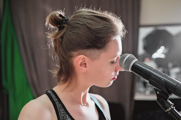 Student practicing scales and breathing exercises in singing instruction class